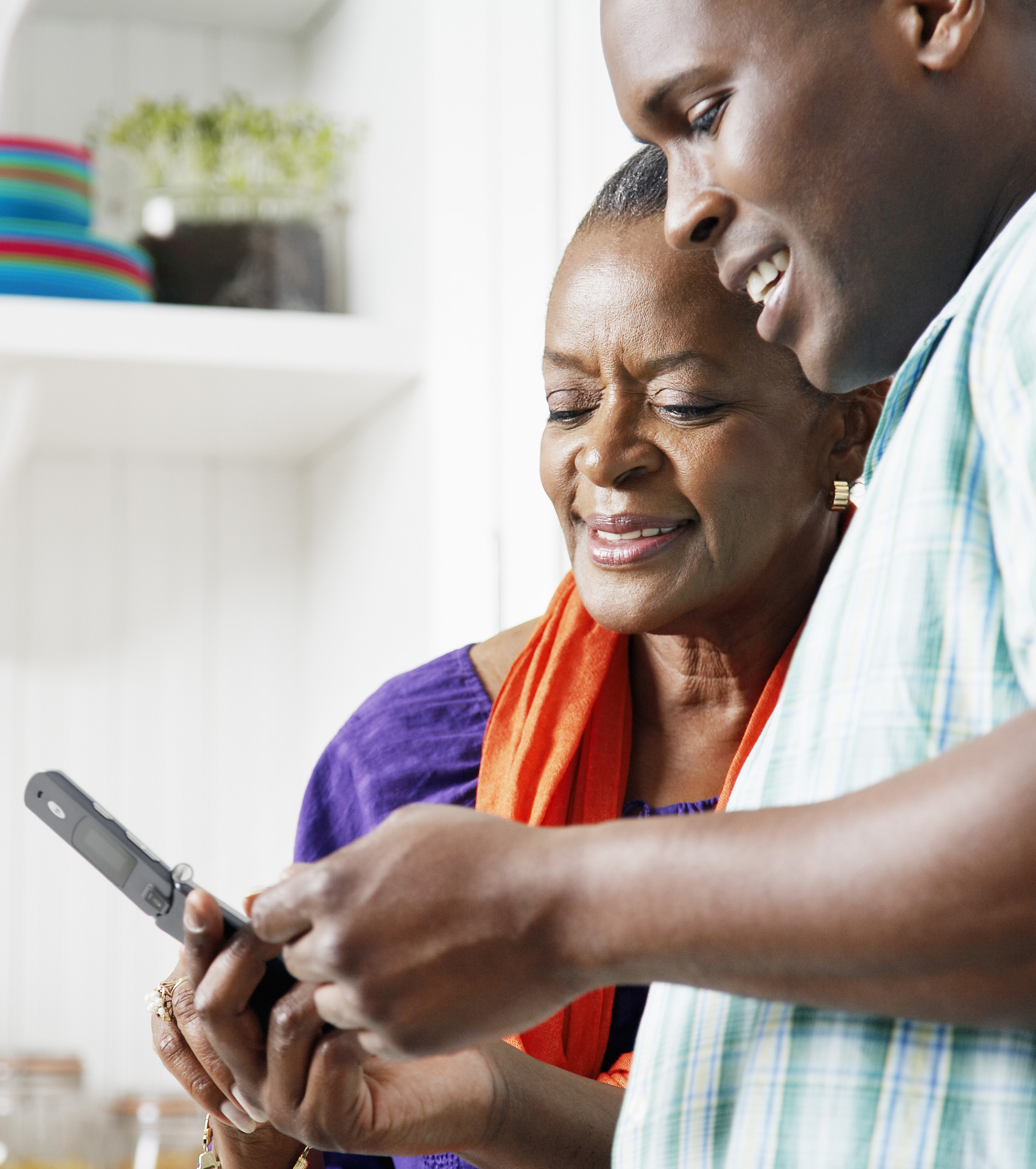 Son showing mother something on the phone.