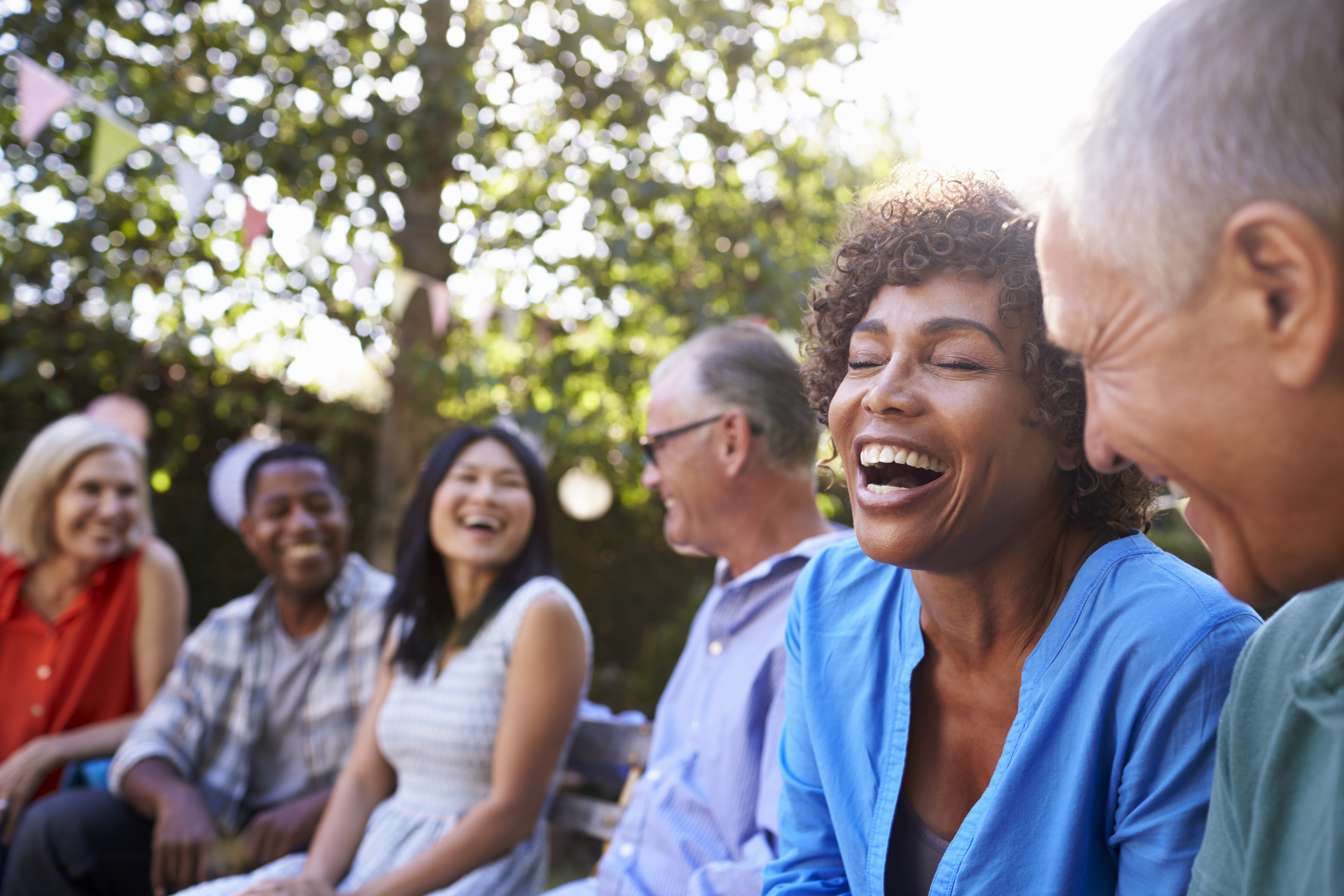 multi-ethnic adults laughing and talking